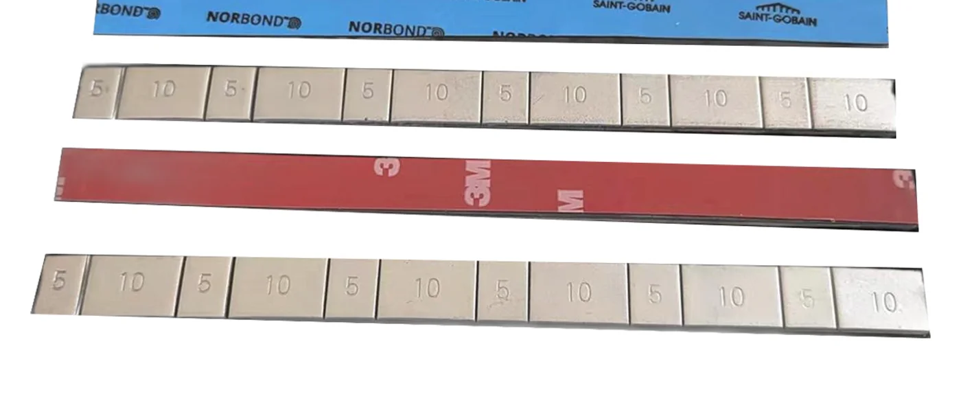 Adhesive wheel weight strips with Norton blue liner and 3M red liner tape